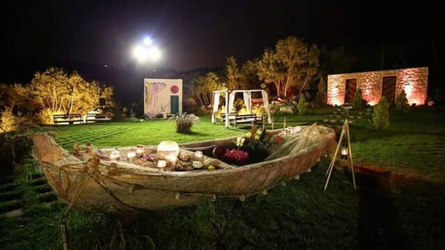 a boat on grass with candles and flowers