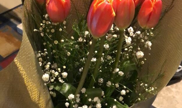 a bouquet of flowers in a paper wrapper