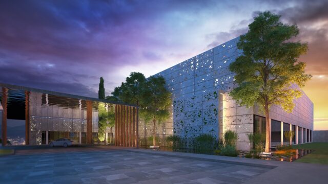 a building with trees and a stone wall