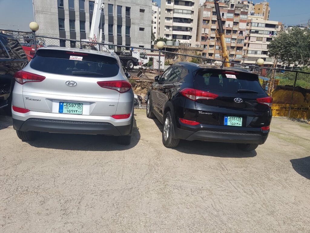 a couple of cars parked in a parking lot