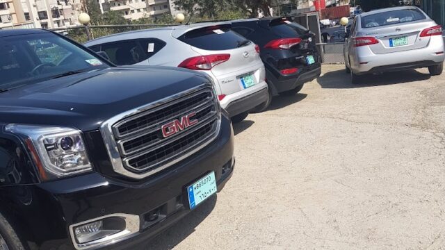 a group of cars parked in a parking lot