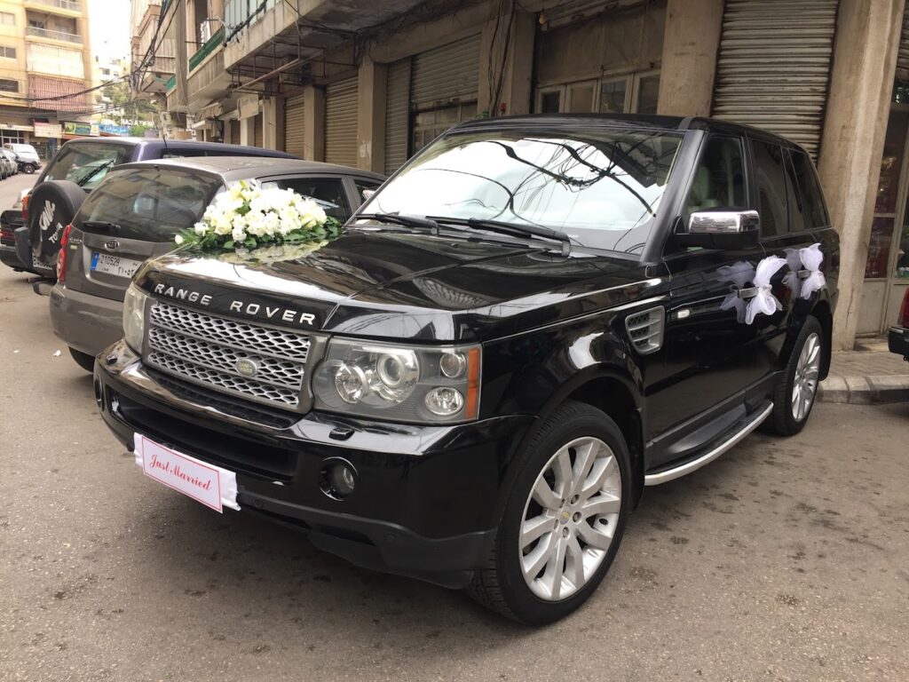 a black car with flowers on the hood