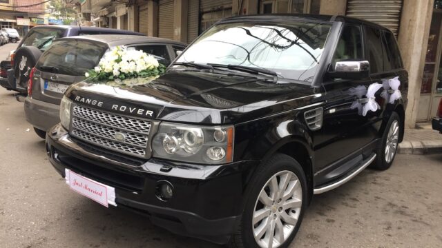 a black car with flowers on the hood