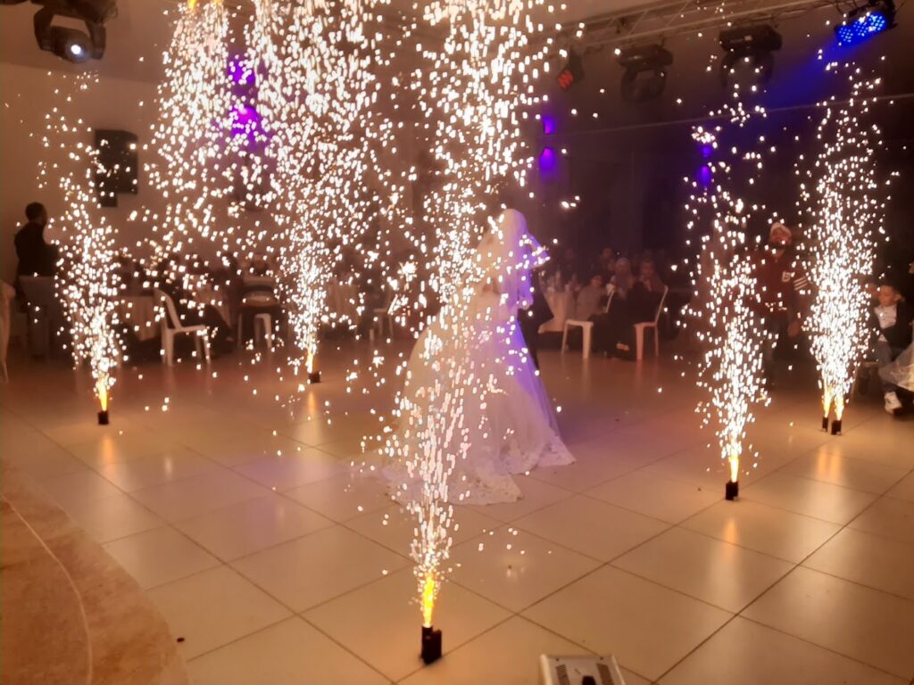 a woman in a dress dancing with fireworks