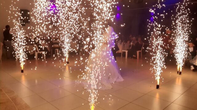 a woman in a dress dancing with fireworks