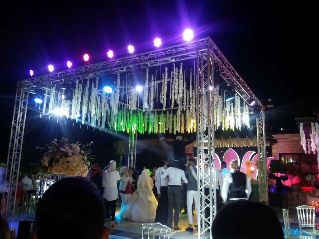 a group of people dancing under a stage