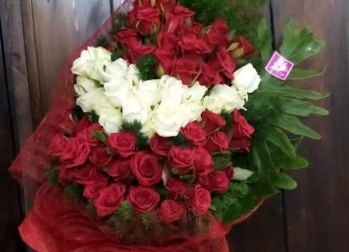 a hand holding a bouquet of flowers