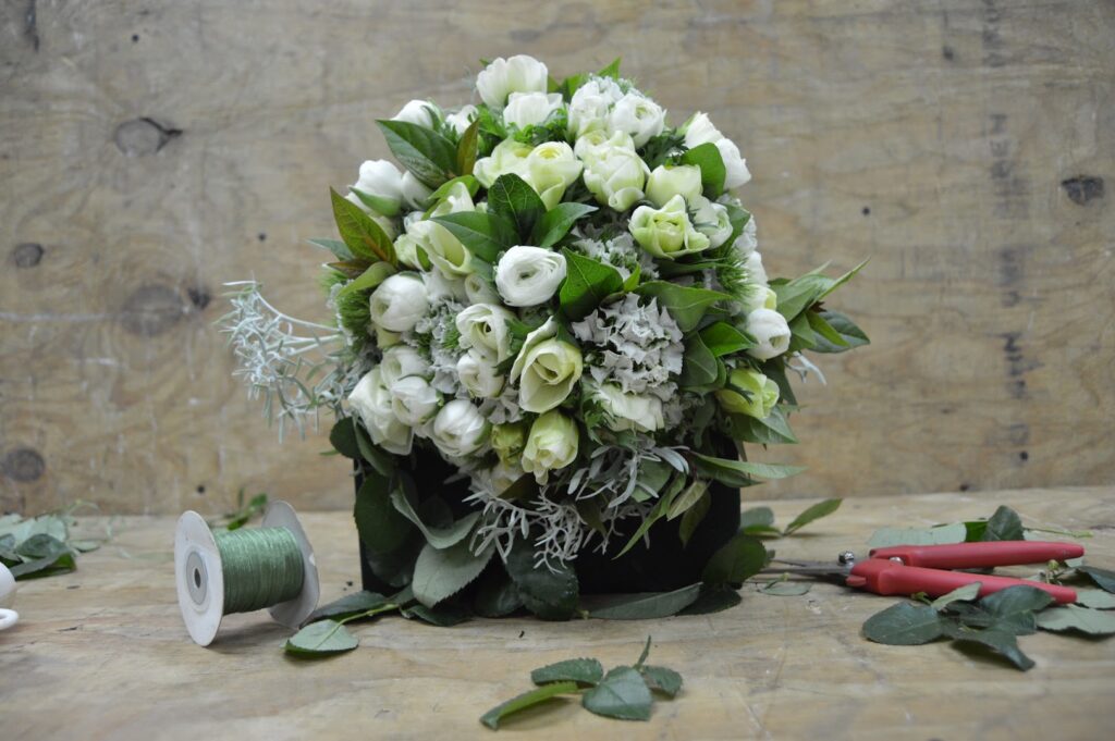 a bouquet of white roses and scissors