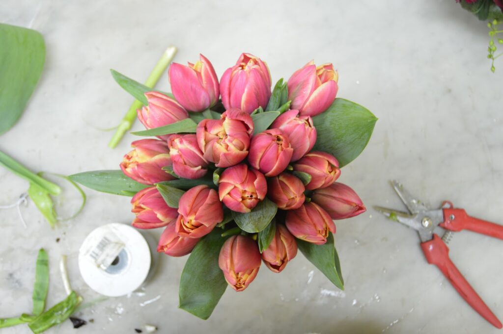 a bouquet of pink tulips and a tape