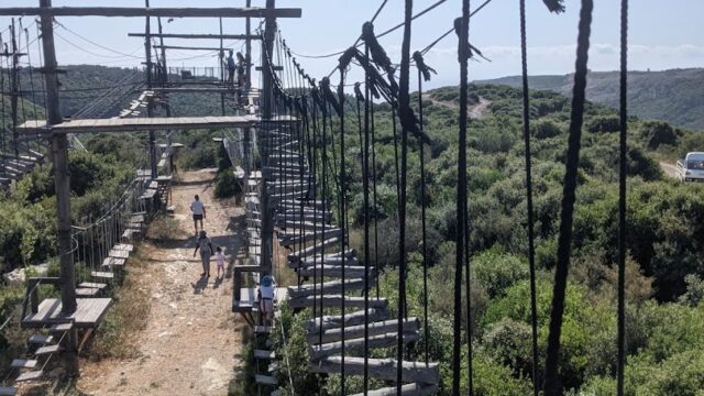 a rope bridge with people walking on it