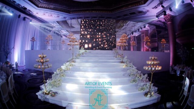 a white stairs with candles and flowers