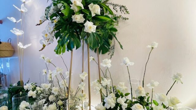 a group of white flowers and candles