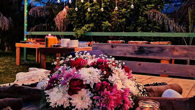 a table with flowers and candles on it