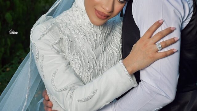 a man and woman in wedding attire hugging