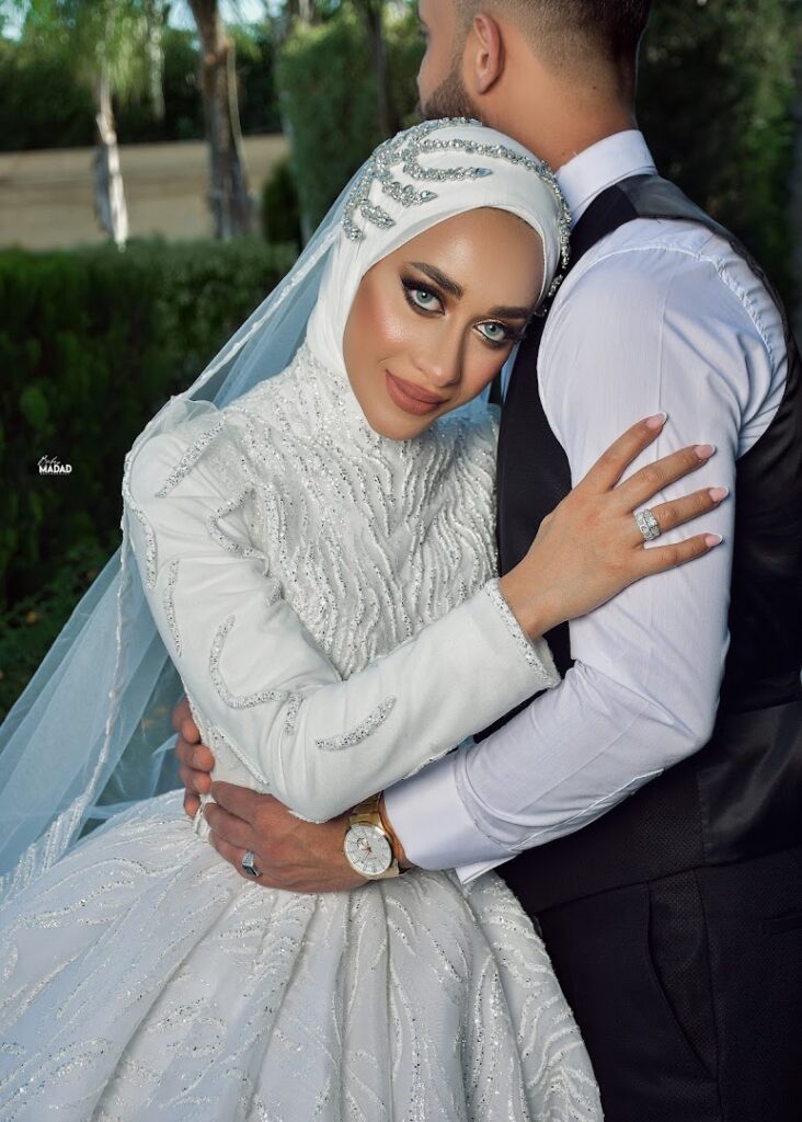 a man and woman in wedding attire hugging