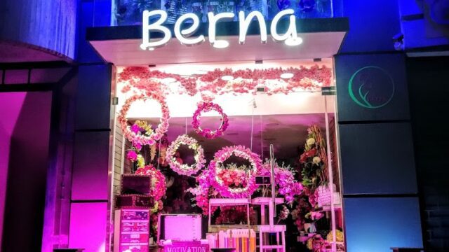 a store front with flowers and lights