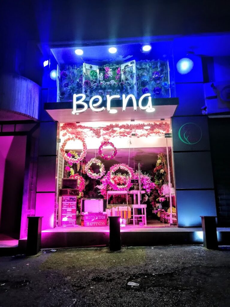 a store front with flowers and lights