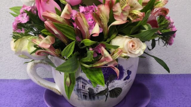 a bouquet of flowers in a tea cup