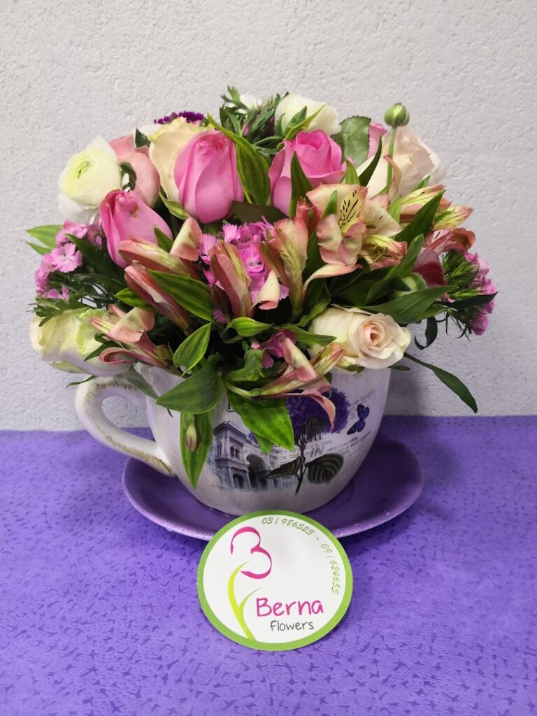 a bouquet of flowers in a tea cup