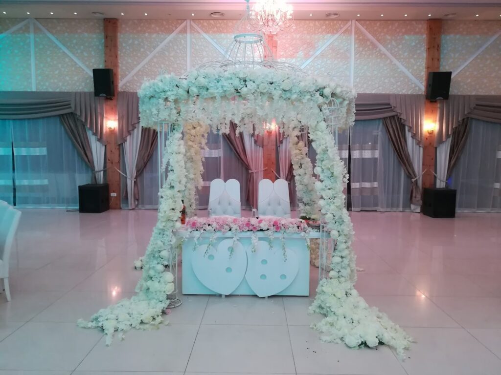 a white table with flowers and a chandelier