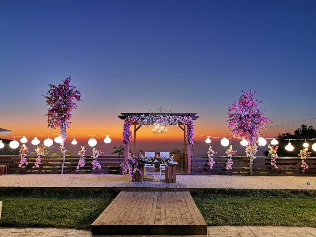 a wedding venue with flowers and lights