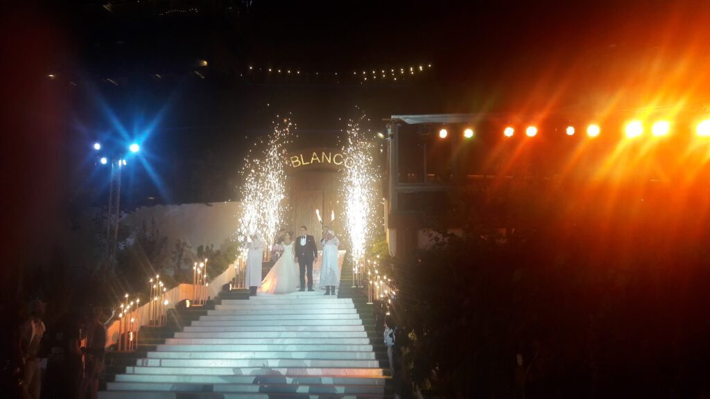 a group of people standing on stairs with fireworks