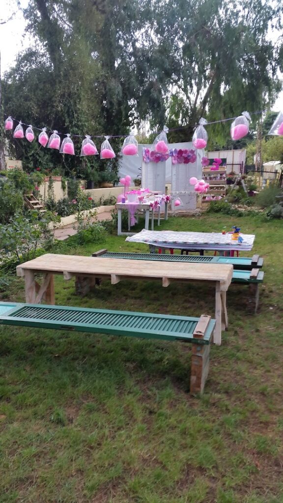 a picnic table with pink balloons from string