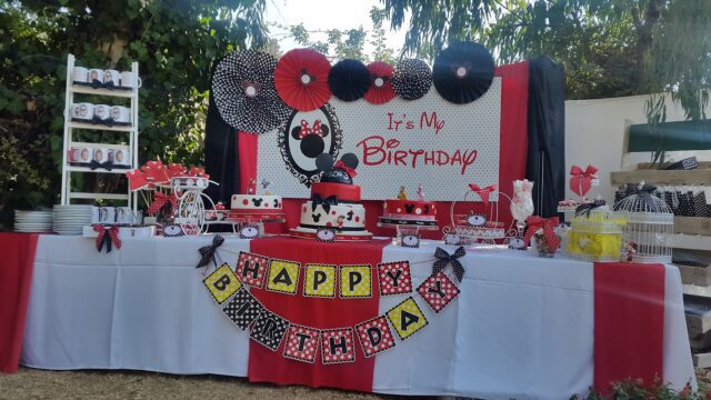 a table with a cake and a banner