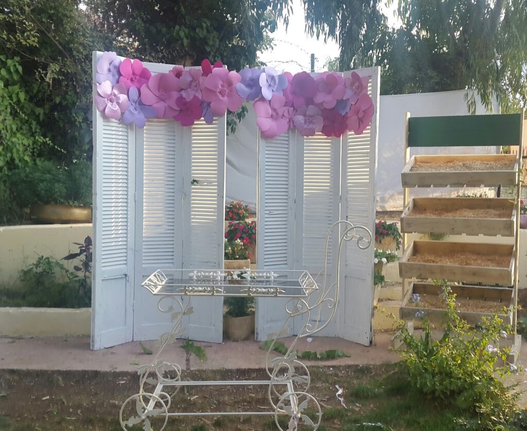 a white folding screen with a table and flowers on it