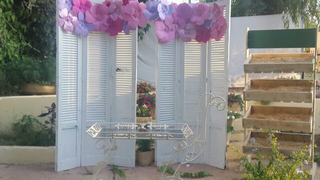 a white folding screen with a table and flowers on it