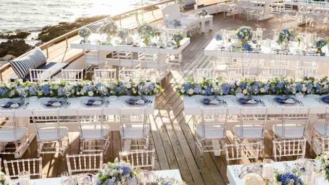 a group of tables set up on a deck with chairs and tables