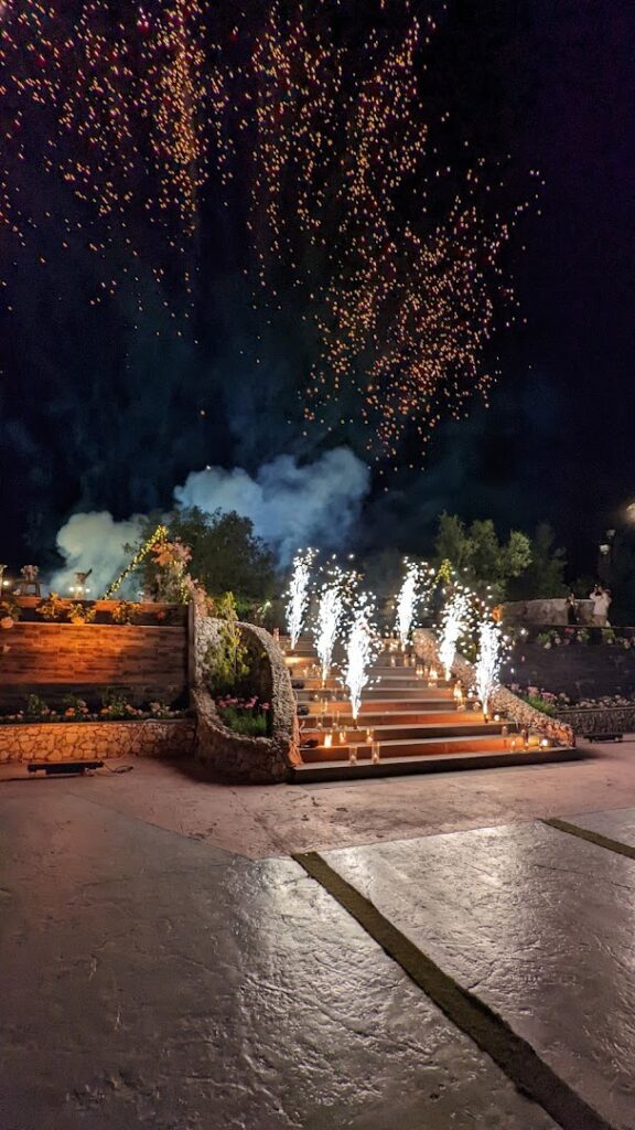 a stairs with lit candles and fireworks in the sky