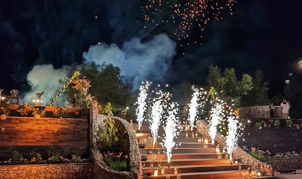 a stairs with lit candles and fireworks in the sky