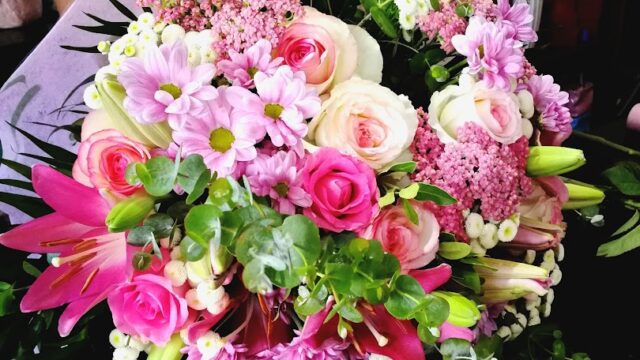 a bouquet of flowers in a person's hand