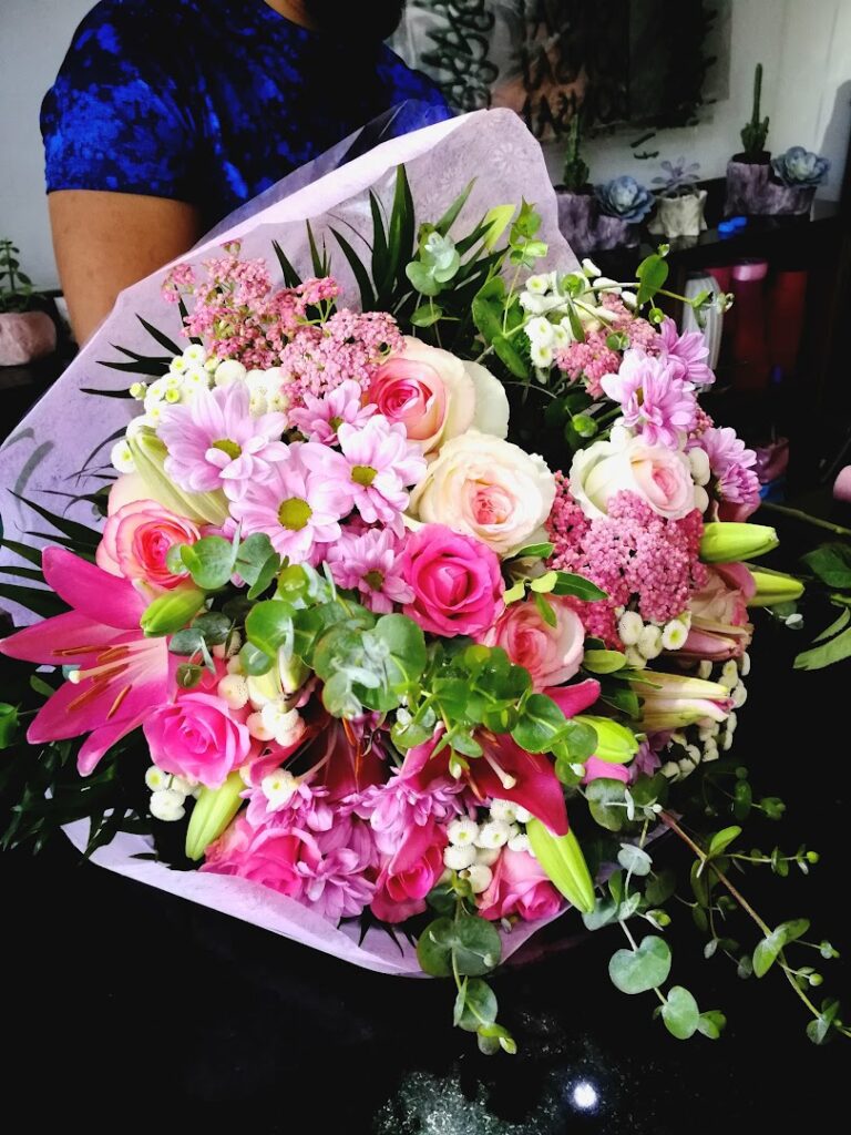 a bouquet of flowers in a person's hand