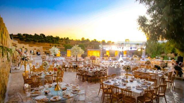 a large outdoor event setting with tables and chairs