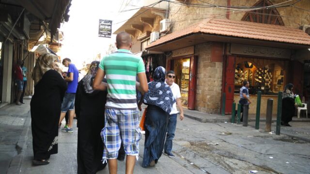 a group of people walking down a street