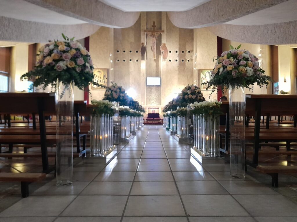 a church with many vases of flowers