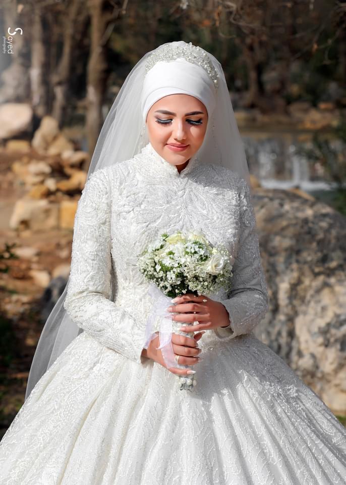 a woman in a wedding dress holding a bouquet