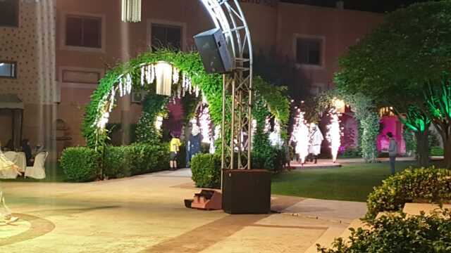 a stage with a speaker and a stage in the middle of a park