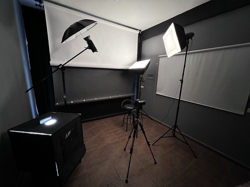 a photo studio with a camera and a chair