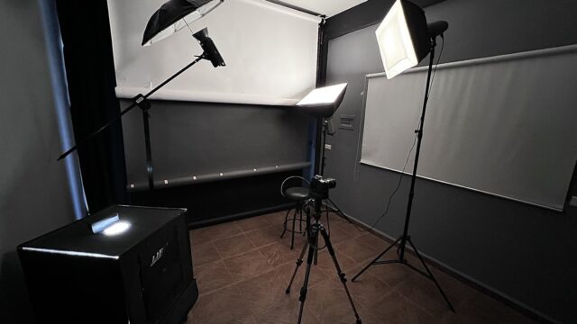 a photo studio with a camera and a chair