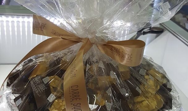 On the table, there is a bag of chocolates labeled with the keyword "Carré Sucré Main Office & Central Kitchen".