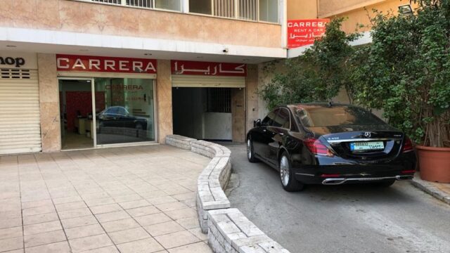 a black car parked in front of a building