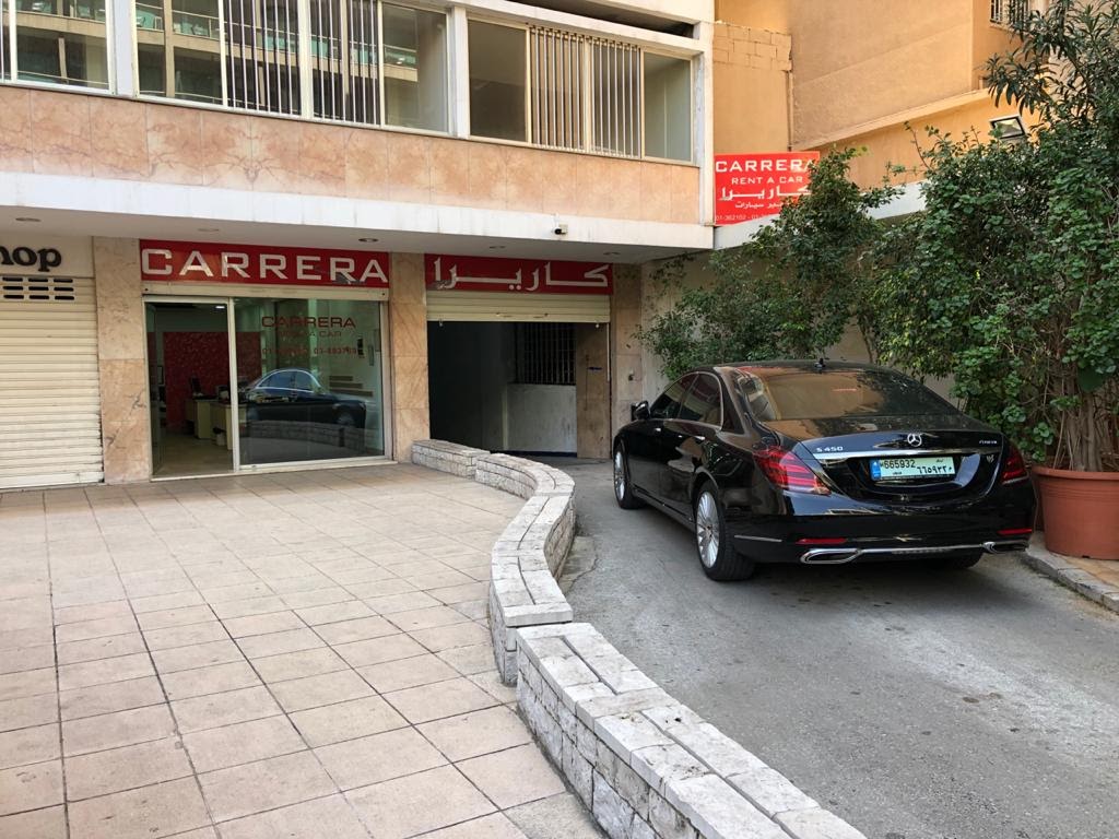 a black car parked in front of a building