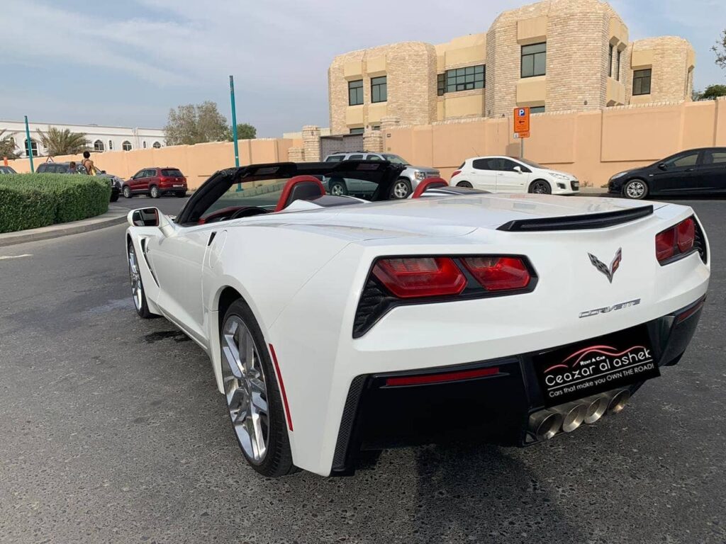 a white convertible car parked in a parking lot