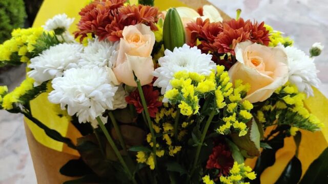 a bouquet of flowers in a yellow wrapper