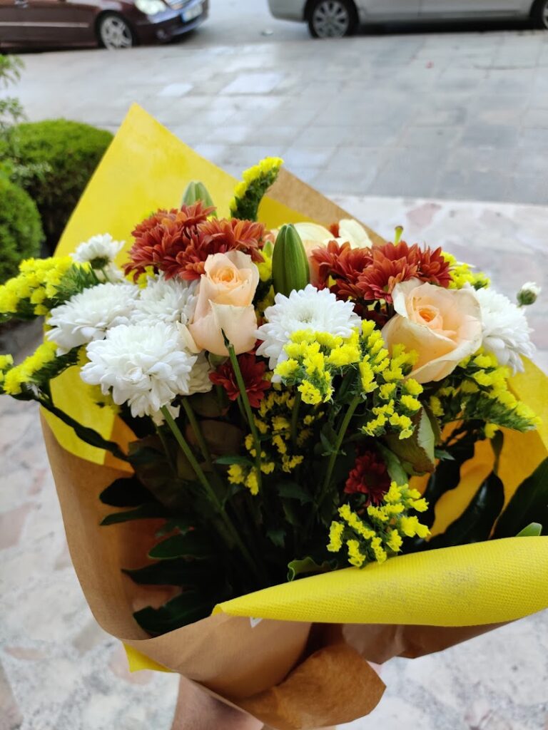 a bouquet of flowers in a yellow wrapper