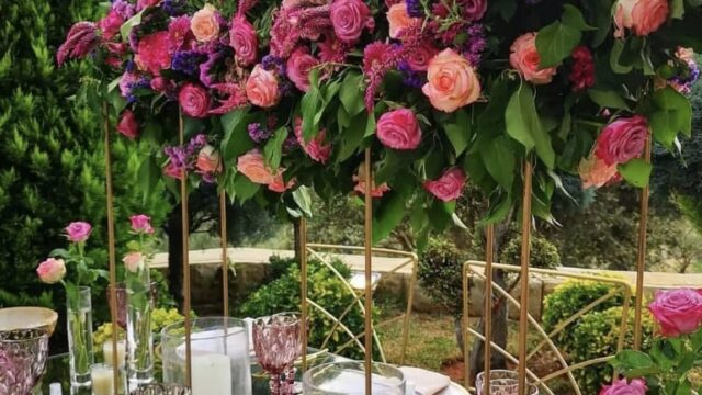 a table set with flowers and candles