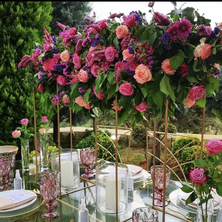 a table set with flowers and candles